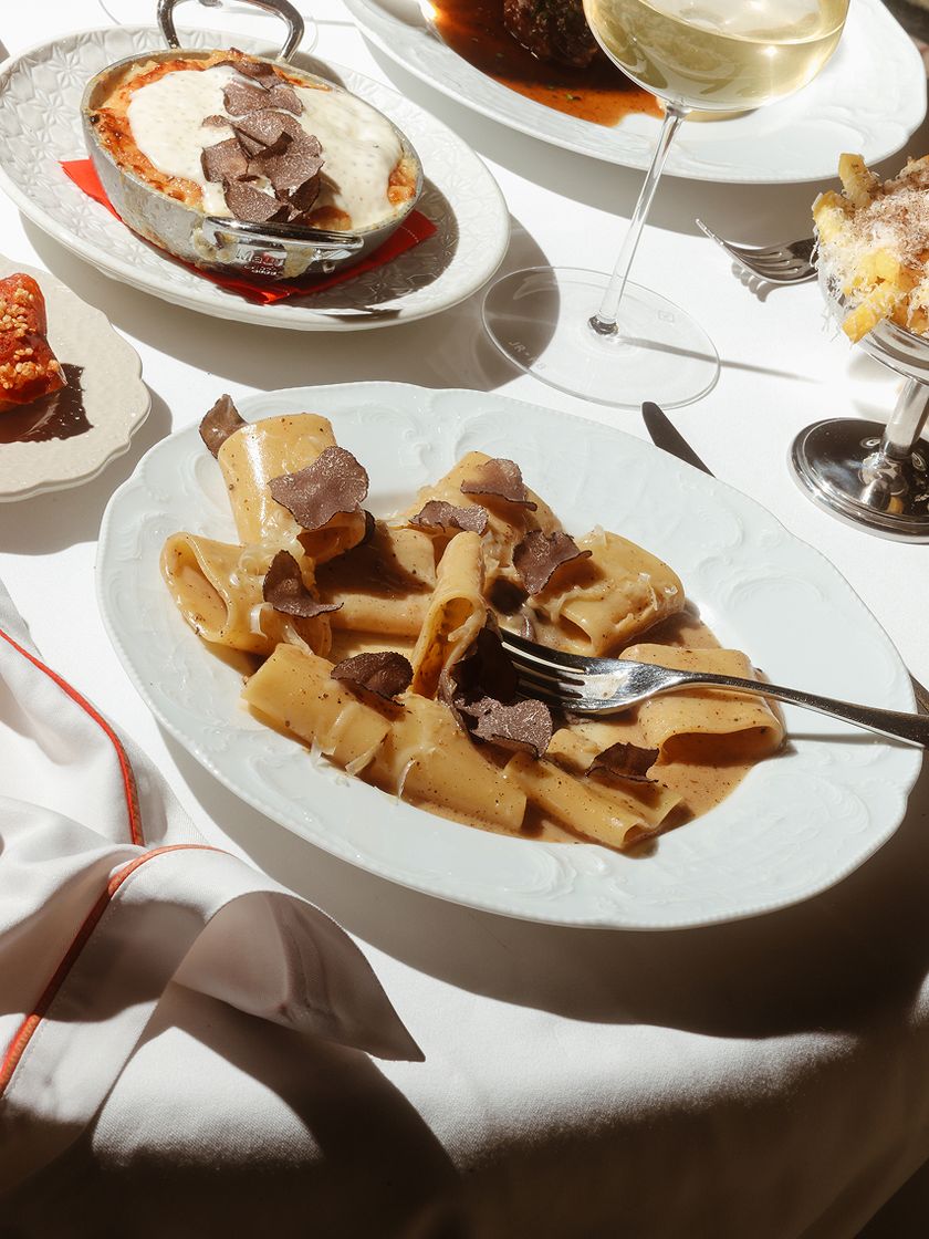 A business lunch laid out at Bisou — several plates on a white tablecloth.