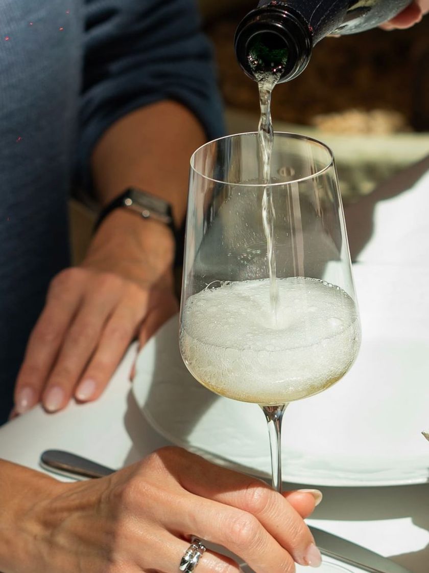 Champagne being poured into a glass at Bisou.